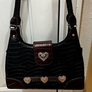 Like new, crocodile material, medium size.